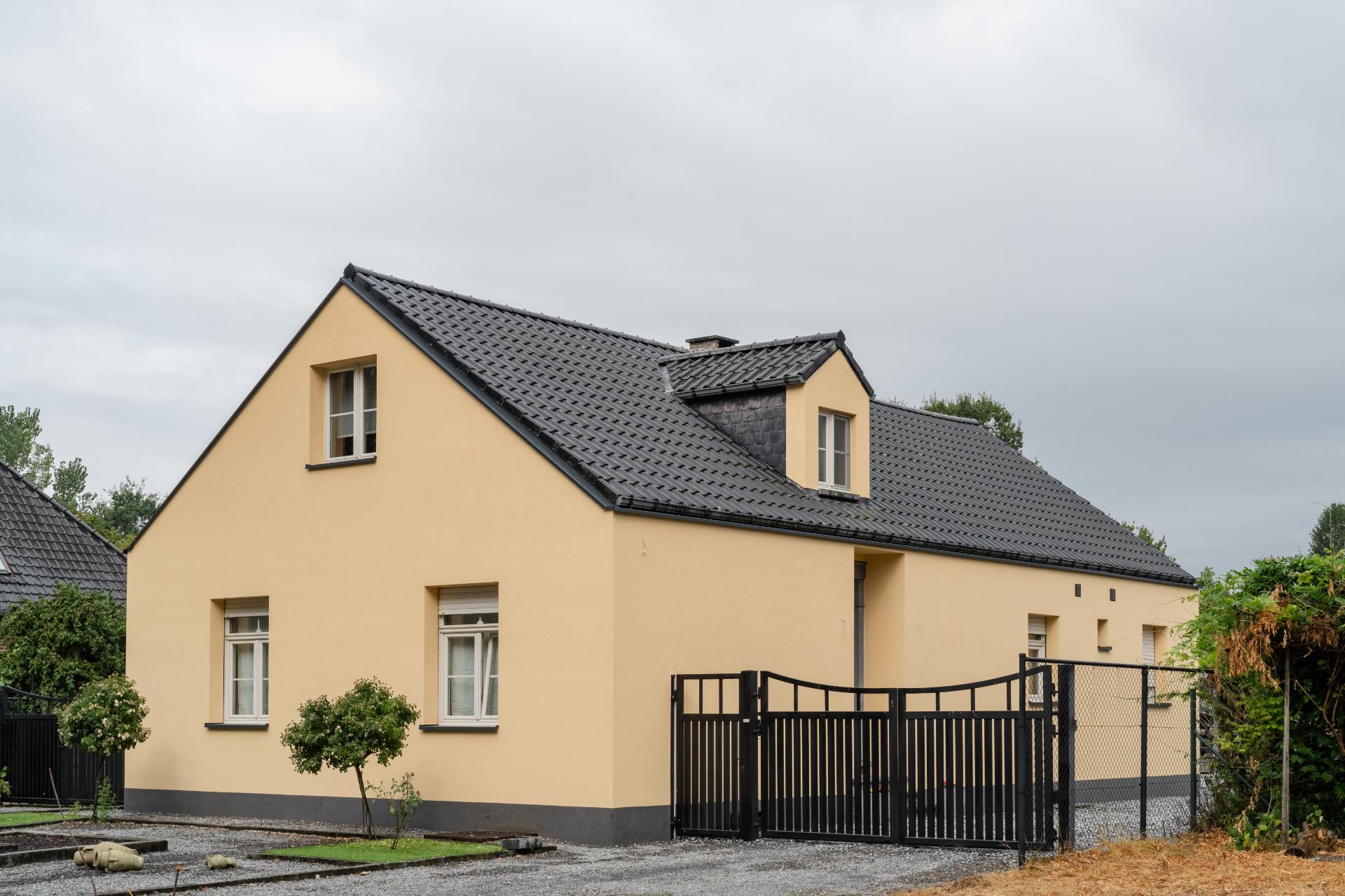 Gerenoveerde woning met gele gevelbepleistering